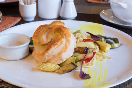 Fish dish with vegetables and sauceの写真素材