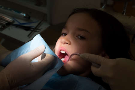 Girl at pediatric dentists office, treatment of baby teethの写真素材