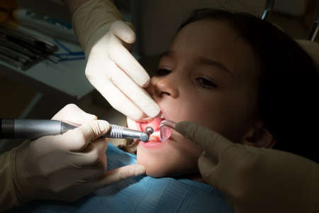 Girl at pediatric dentists office, treatment of baby teethの写真素材
