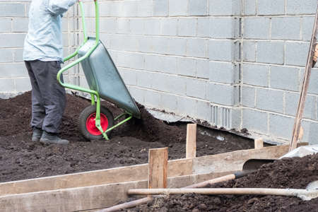Work in the garden with a wheelbarrow and ground in gardenの写真素材