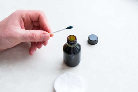 Remove green antiseptic. Man stained in zelenka.の写真素材