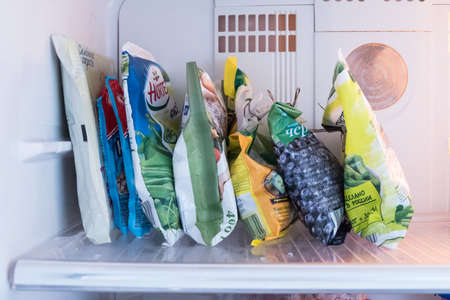 Frozen food in the freezer. Products for the winter in the refrigeratorのeditorial素材