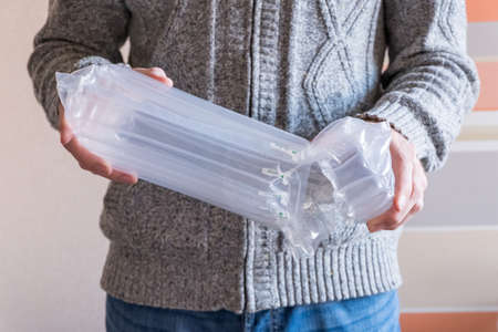 translucent air packaging hands hold, protection of goods, plastic packagingの写真素材