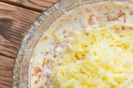 The process of cooking fish salad Mimosa. Laying potatoes and mayonnaiseの写真素材