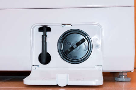 Washing machine with an open filter coverの写真素材
