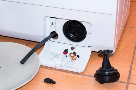 Service of the washing machine, got a small garbage from the filterの写真素材