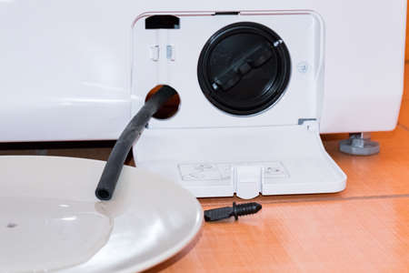 Service of the washing machine, the filter with a tube, water poursの写真素材