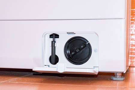 Washing machine with an open filter coverの写真素材