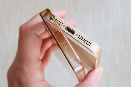 Silicone case for smartphone bent in his handの写真素材