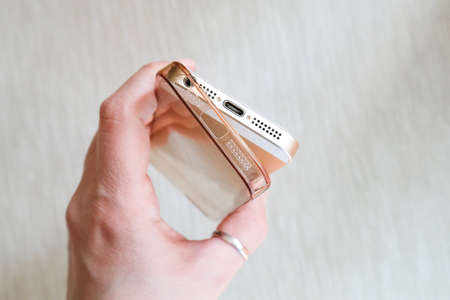 Silicone case for smartphone bent in his handの写真素材