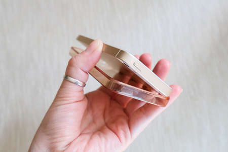 Silicone case for smartphone bent in his handの写真素材