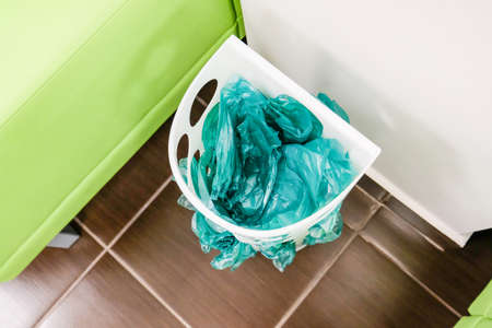 Green shoe covers in a basket. Disposable shoe covers at the medical centerの写真素材