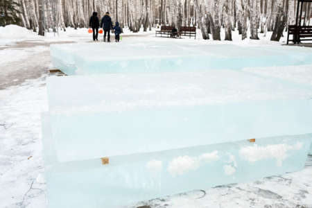 Ice cut into blocks for the construction of an ice town. Ice bricks lie on wooden props.の写真素材