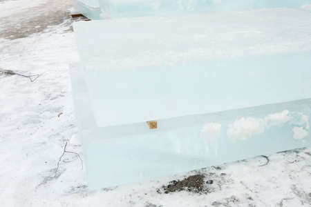 Ice cut into blocks for the construction of an ice town. Ice bricks lie on wooden props.の写真素材