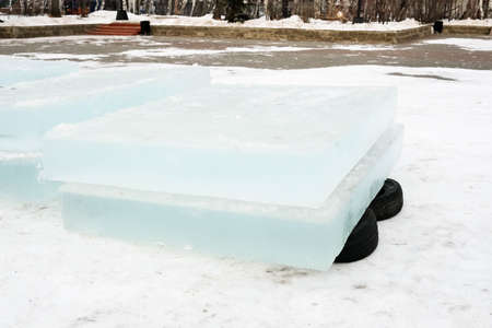 Ice blocks lie on rubber tires. Ice for building an ice townの写真素材