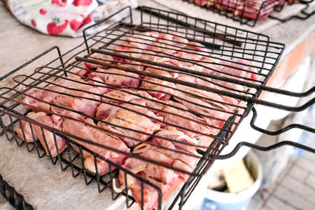 Raw pork on the grill. Skewers of pig meat on the tableの写真素材