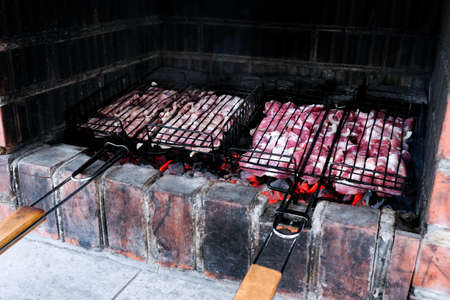 Barbecue on the grill. Brick stove. Cooking meat on charcoal. Cook pork outdoors.の写真素材