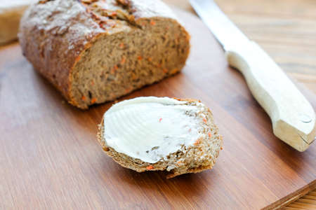 Slice of bread with butter. Sliced Carrot Bread. View from aboveの写真素材