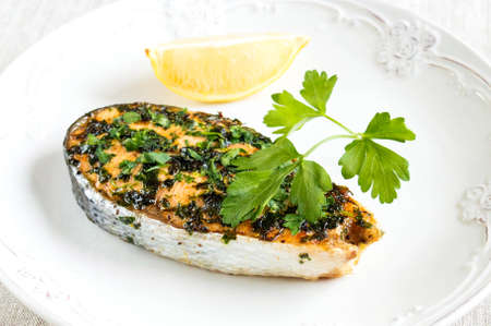 Salmon steak with parsley and lemon. Serving red fishの写真素材