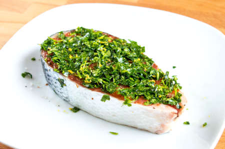 Raw salmon with salt, pepper and herbs. Red fish in marinadeの写真素材