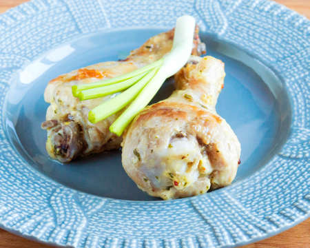 Fried chicken drumstick on a plate. Appetizing Chicken with Green Onionsの写真素材