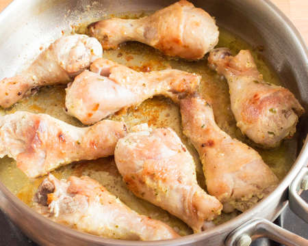 Fried chicken drumstick in a pan. Appetizing chicken with a crustの写真素材