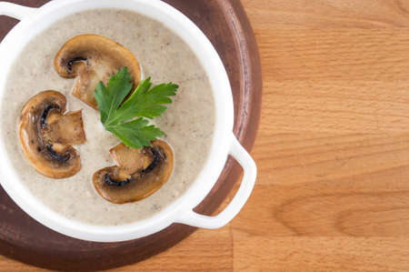 Mushroom cream soup, top view. Place for text, wooden background.の写真素材