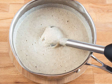 Cream soup in a pan. Blender portion in the soup. Grind puree soup ingredients.の写真素材