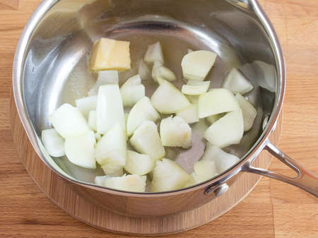 Fry onions with butter. Metal bucket. For making soup.の写真素材