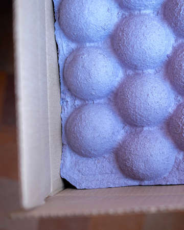 Tight packing for fixing goods in a box. Vertical photo, blurred background. Purple hemispheresの写真素材