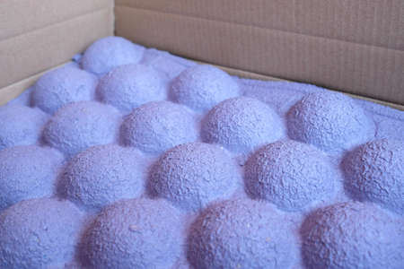 Unusual paper packaging for the transport of goods. Thick purple packaging for the safety of the parcelの写真素材