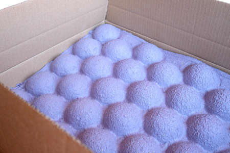 Unusual paper packaging for the transport of goods. Thick purple packaging for the safety of the parcel. Blurred edgesの写真素材