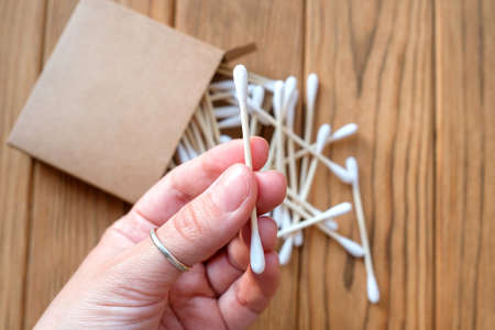 Cotton swab in hand. Eco-friendly ear cleaning and beauty stickの写真素材