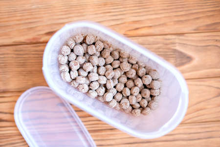 Bran in a plastic container. Dry edible ballsの写真素材