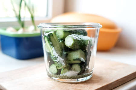 Fresh cucumbers in a glass jar with spices. Preparation for saltingの写真素材