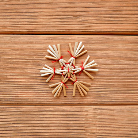 The snowflake is made of straw and tied with red threadsの写真素材