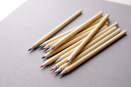 Eco-friendly pencils on a gray background. Colored recyclable crayons. Several colored pencils lie on gray paper.の写真素材
