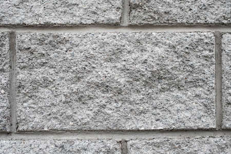 One gray embossed brick. Masonry wall, background.の写真素材