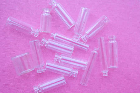 Transparent small bubbles on pink background. Glass jarsの写真素材