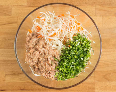 Ingredients in a transparent mixing bowl. Fish salad.の写真素材