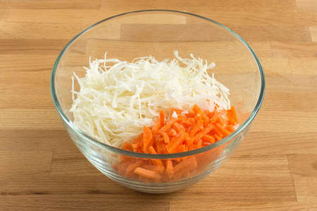 White cabbage and carrots in a transparent salad bowl. For salad.の写真素材