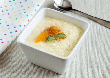 Rice pudding in a tall, square serving bowl. Dessert.の写真素材