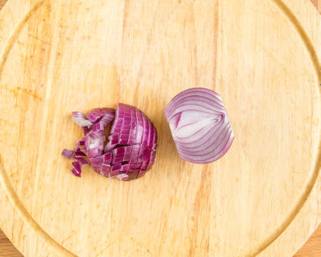 Cut the red onion into small cubes. Top view of purple bow.の写真素材
