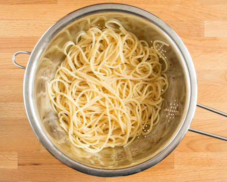 Boiled spaghetti in a colander without spices. Draining.の写真素材