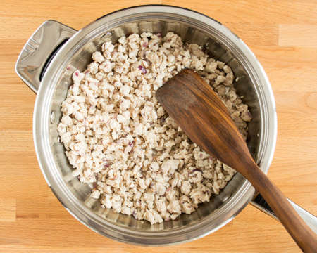 Minced chicken with onions mixed in a pan.の写真素材