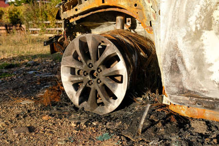 Details of the wheel of a burnt-out car. No one.の写真素材
