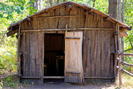 Flimsy wooden house in the forest. No people.
