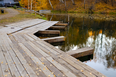 Wide boardwalk for boats. Part of the lake is visible. No people, autumn.の写真素材