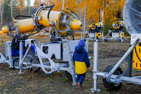 Installations for snowing the mountain slope. Autumn storage. The child walks around the technique.のeditorial素材