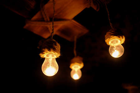 Several bulbs are burning in the dark.